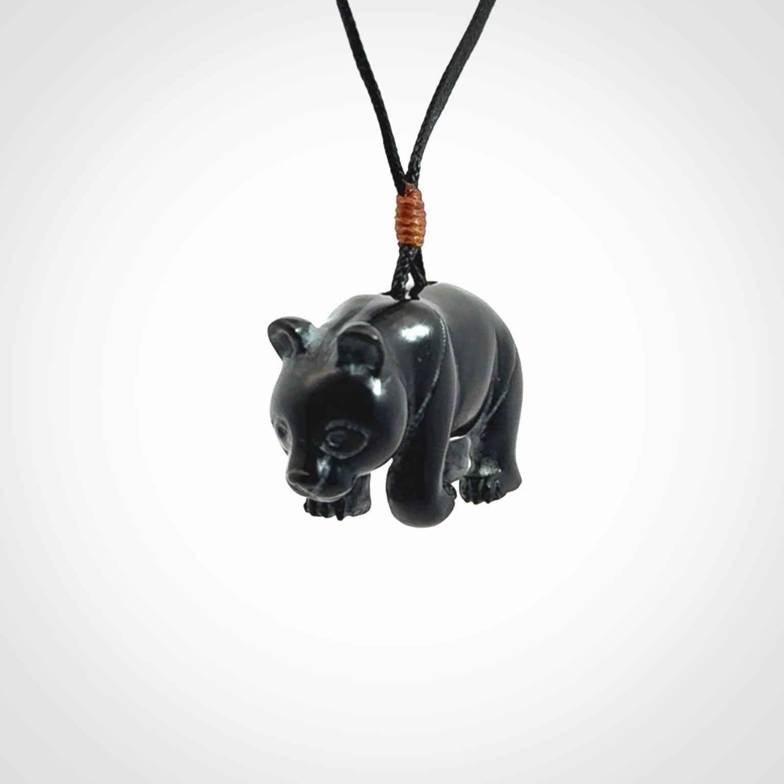 This picture shows a pendant that we designed in black jade. It is a little black bear that has a walking stance and is carved in detail. A really attractive and eye-catching piece of handmade jewellery. The cord is black and the length can be adjusted.