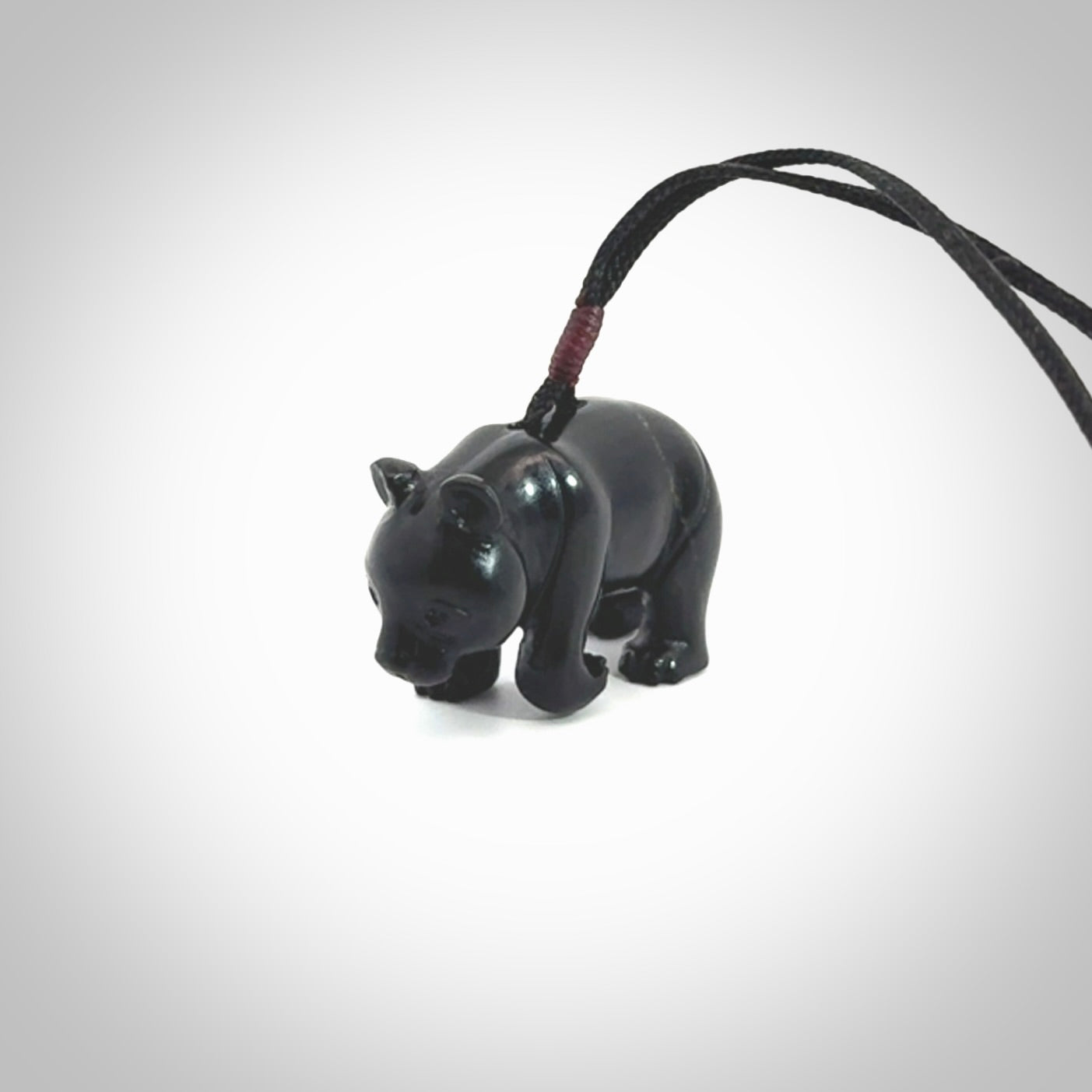 This picture shows a pendant that we designed in black jade. It is a little black bear that has a walking stance and is carved in detail. A really attractive and eye-catching piece of handmade jewellery. The cord is black and the length can be adjusted.