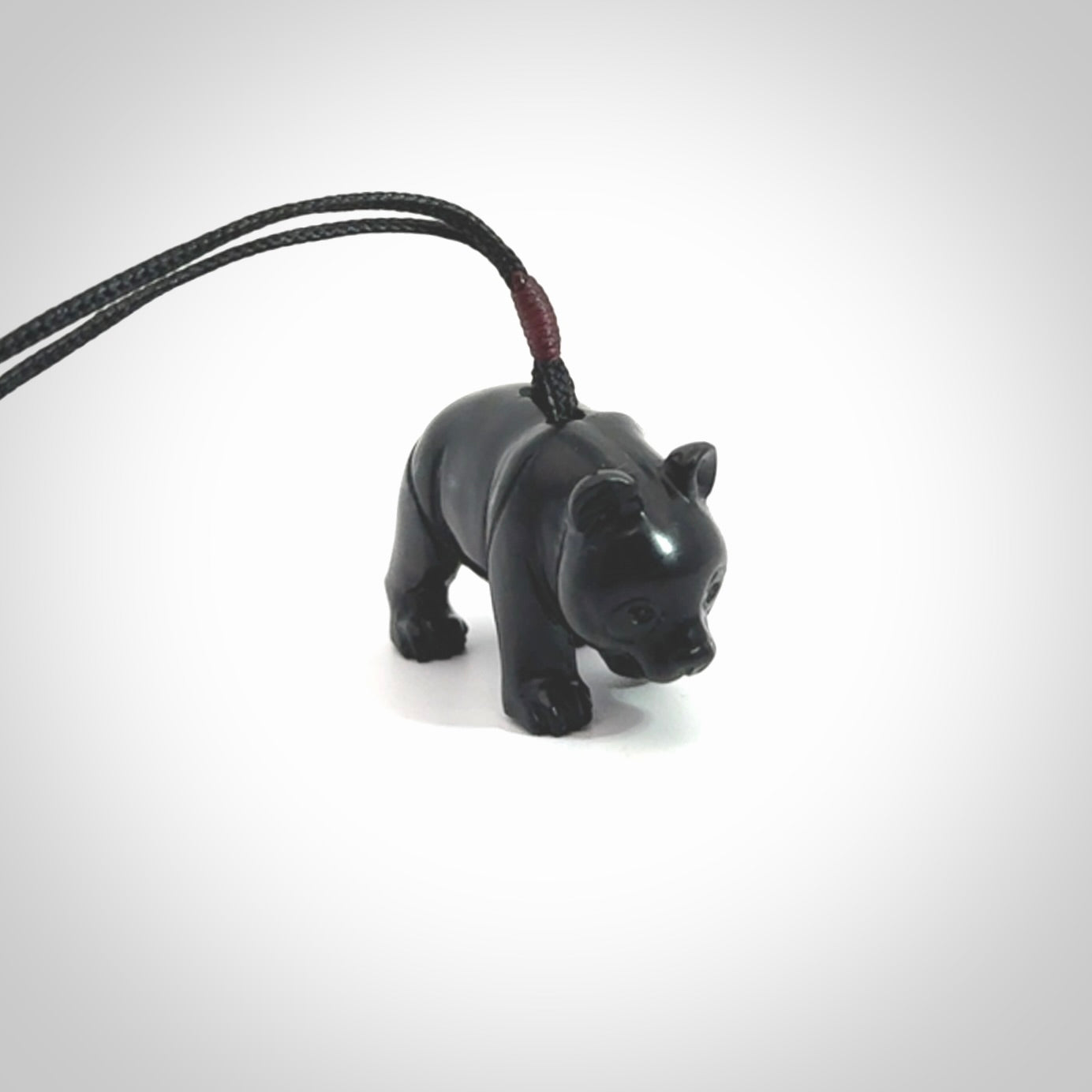 This picture shows a pendant that we designed in black jade. It is a little black bear that has a walking stance and is carved in detail. A really attractive and eye-catching piece of handmade jewellery. The cord is black and the length can be adjusted.