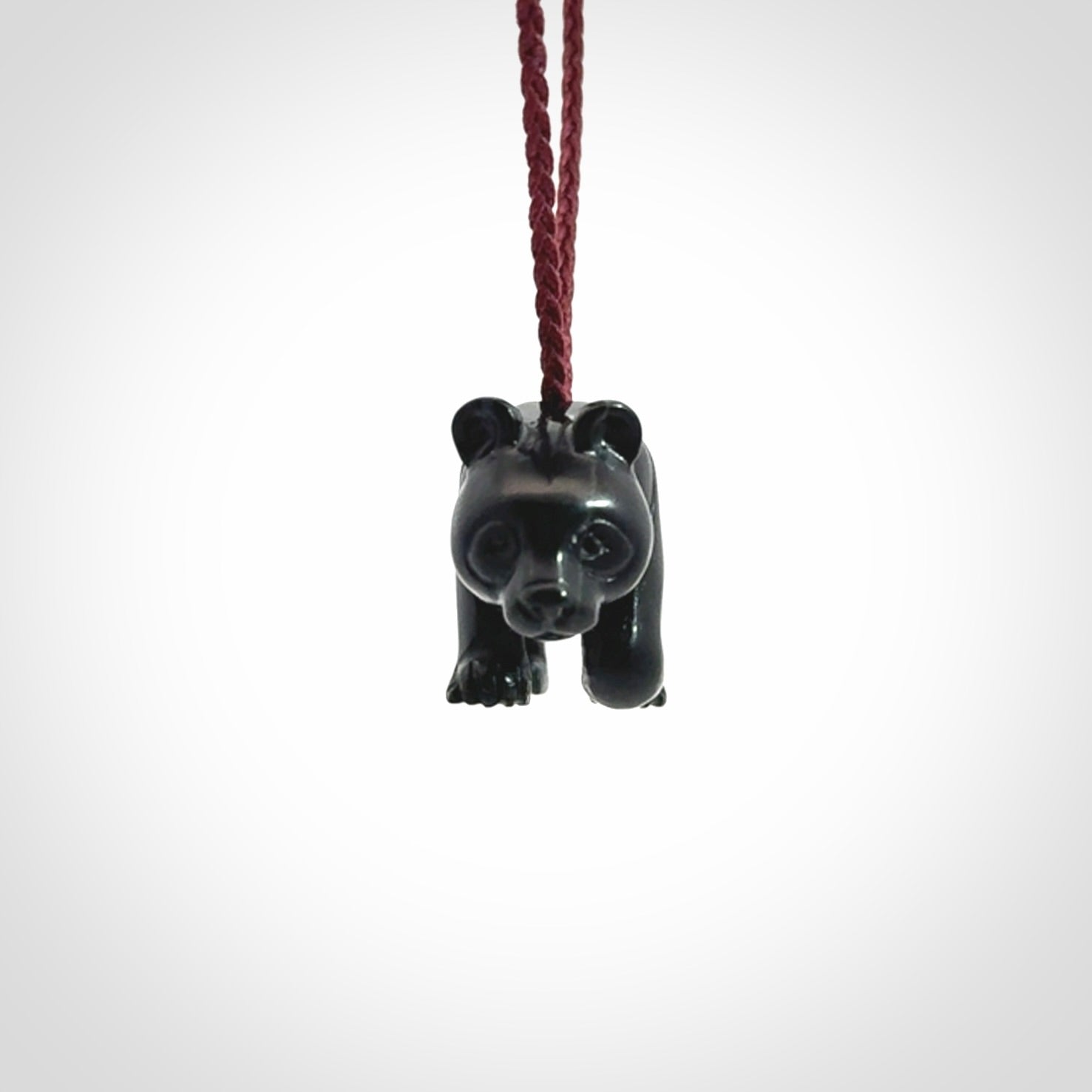 This picture shows a pendant that we designed in black jade. It is a little black bear that has a walking stance and is carved in detail. A really attractive and eye-catching piece of handmade jewellery. The cord is burgundy and the length can be adjusted.
