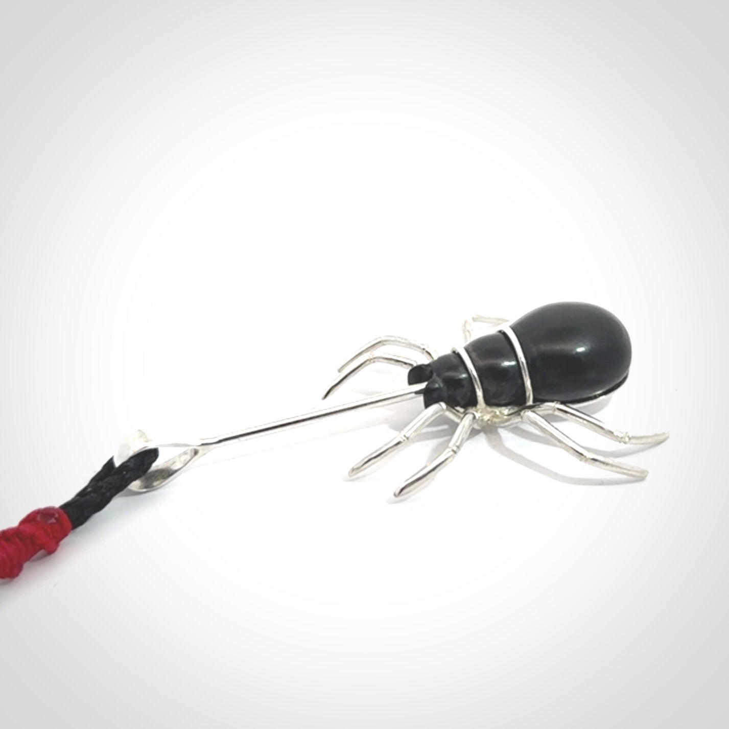 Hand crafted black jade and sterling silver spider necklace. This necklace is provided with a black adjustable cord. Contemporary black jade spider necklace with sterling silver. Delivered with express courier and packaged in a woven kete pouch.