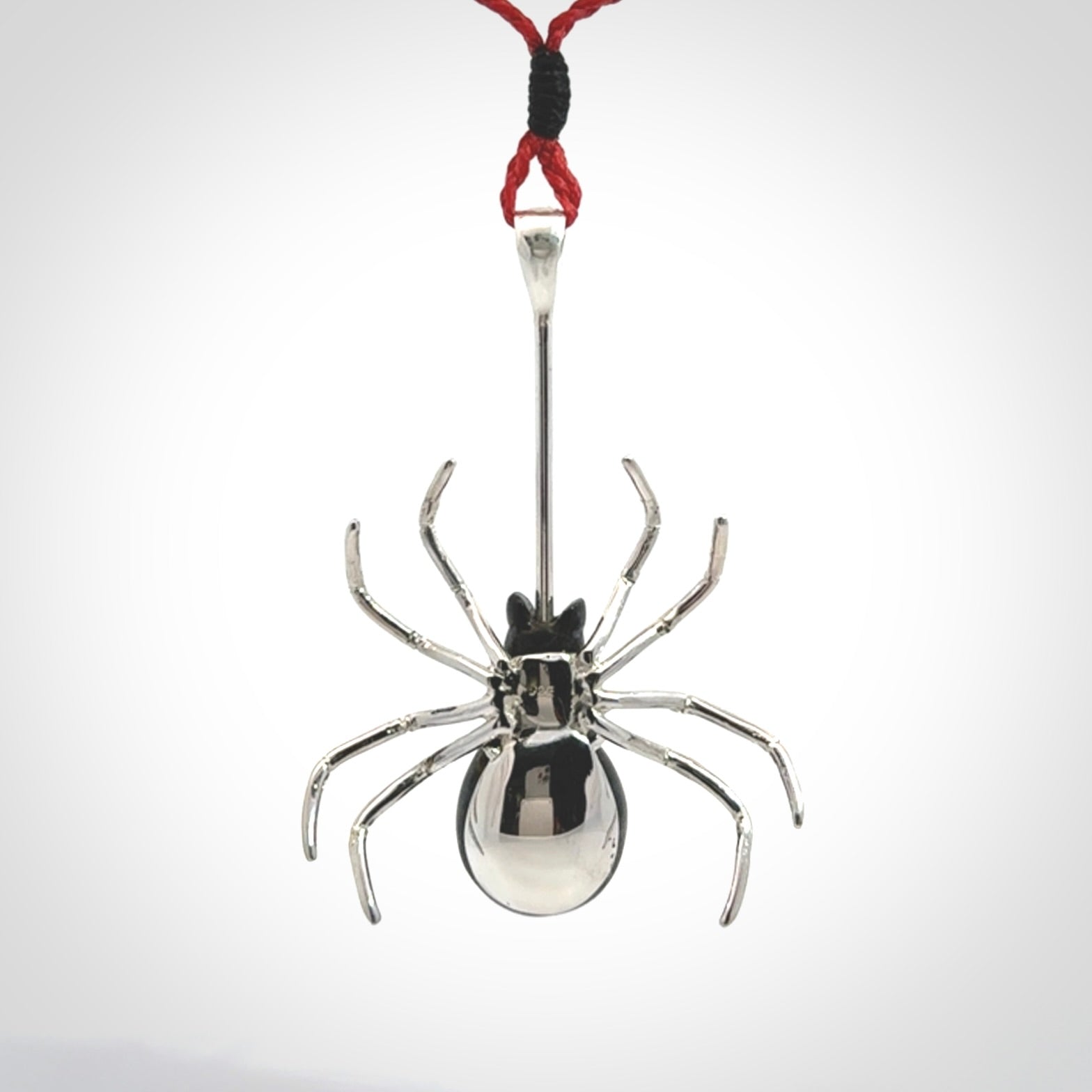 Hand crafted black jade and sterling silver spider necklace. This necklace is provided with a red adjustable cord. Contemporary black jade spider necklace with sterling silver. Delivered with express courier and packaged in a woven kete pouch.