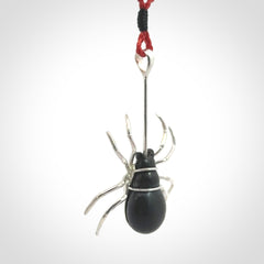 Hand crafted black jade and sterling silver spider necklace. This necklace is provided with a red adjustable cord. Contemporary black jade spider necklace with sterling silver. Delivered with express courier and packaged in a woven kete pouch.
