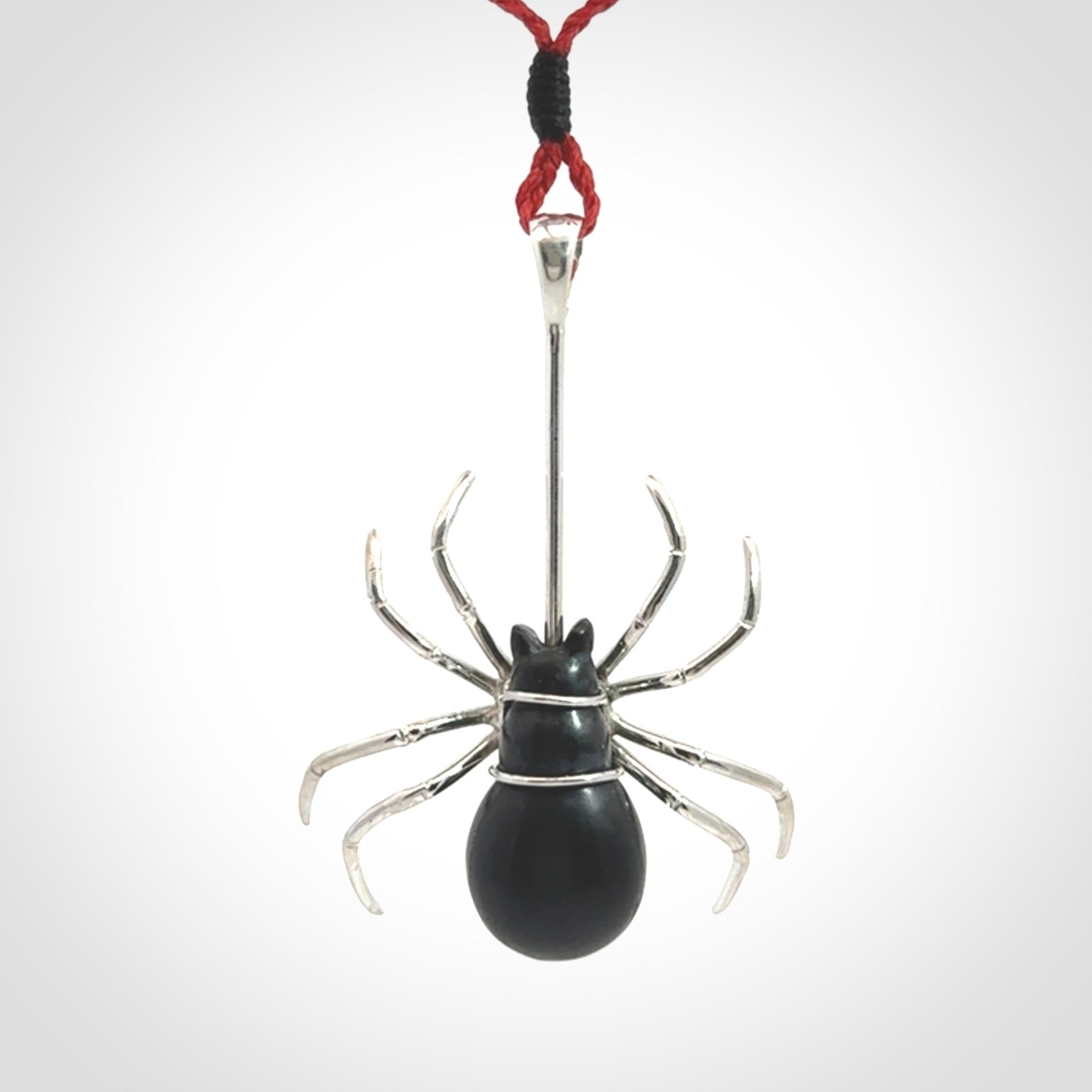Hand crafted black jade and sterling silver spider necklace. This necklace is provided with a red adjustable cord. Contemporary black jade spider necklace with sterling silver. Delivered with express courier and packaged in a woven kete pouch.