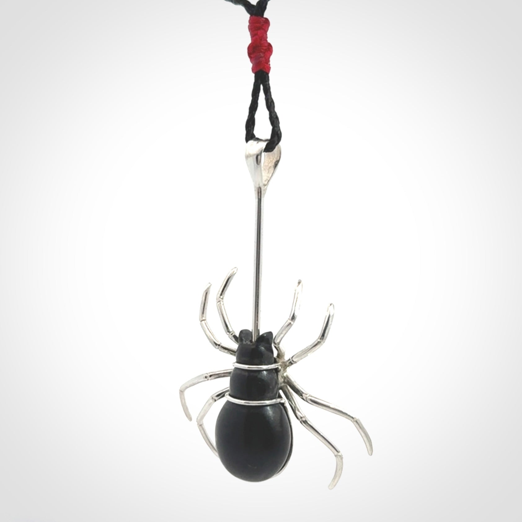 Hand crafted black jade and sterling silver spider necklace. This necklace is provided with a black adjustable cord. Contemporary black jade spider necklace with sterling silver. Delivered with express courier and packaged in a woven kete pouch.
