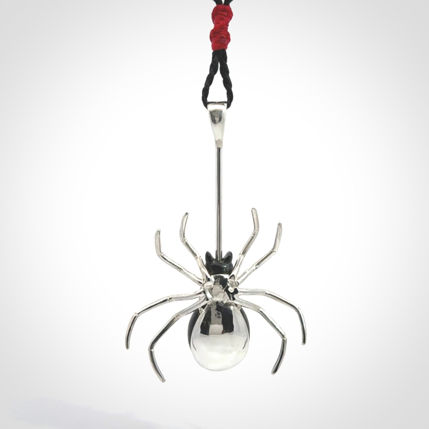 Hand crafted black jade and sterling silver spider necklace. This necklace is provided with a black adjustable cord. Contemporary black jade spider necklace with sterling silver. Delivered with express courier and packaged in a woven kete pouch.