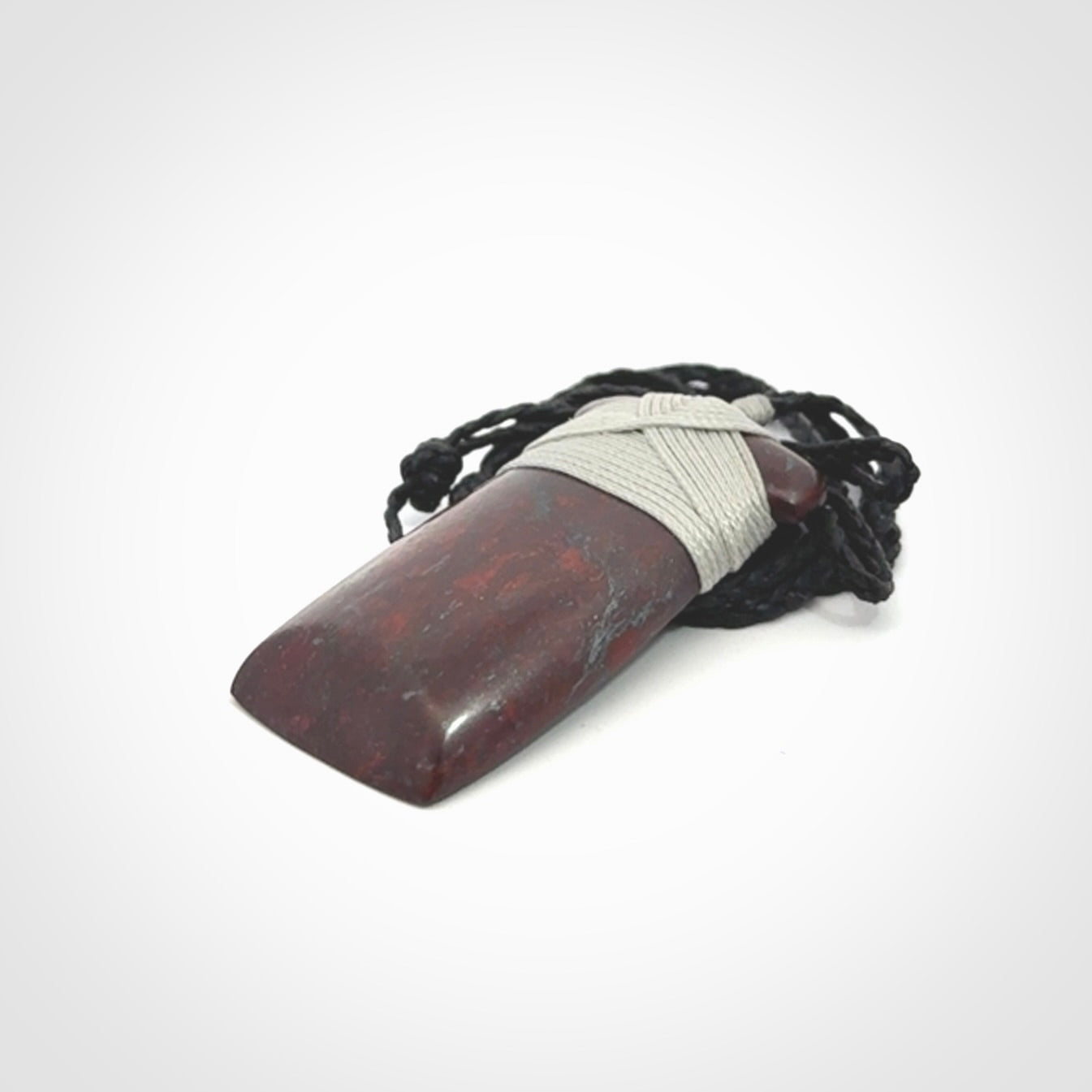 This is a beautiful hand carved Red Jasper Stone toki pendant. A really cool piece that is made from this rare and beautiful material. The red jasper has a very distinctive look and each piece is different. We ship this worldwide and the cost of shipping is included in the price. Provided with adjustable cords and packaged in a woven kete pouch.