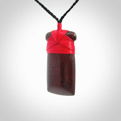 This is a beautiful hand carved Red Jasper Stone toki pendant. A really cool piece that is made from this rare and beautiful material. The red jasper has a very distinctive look and each piece is different. We ship this worldwide and the cost of shipping is included in the price. Provided with adjustable cords and packaged in a woven kete pouch.