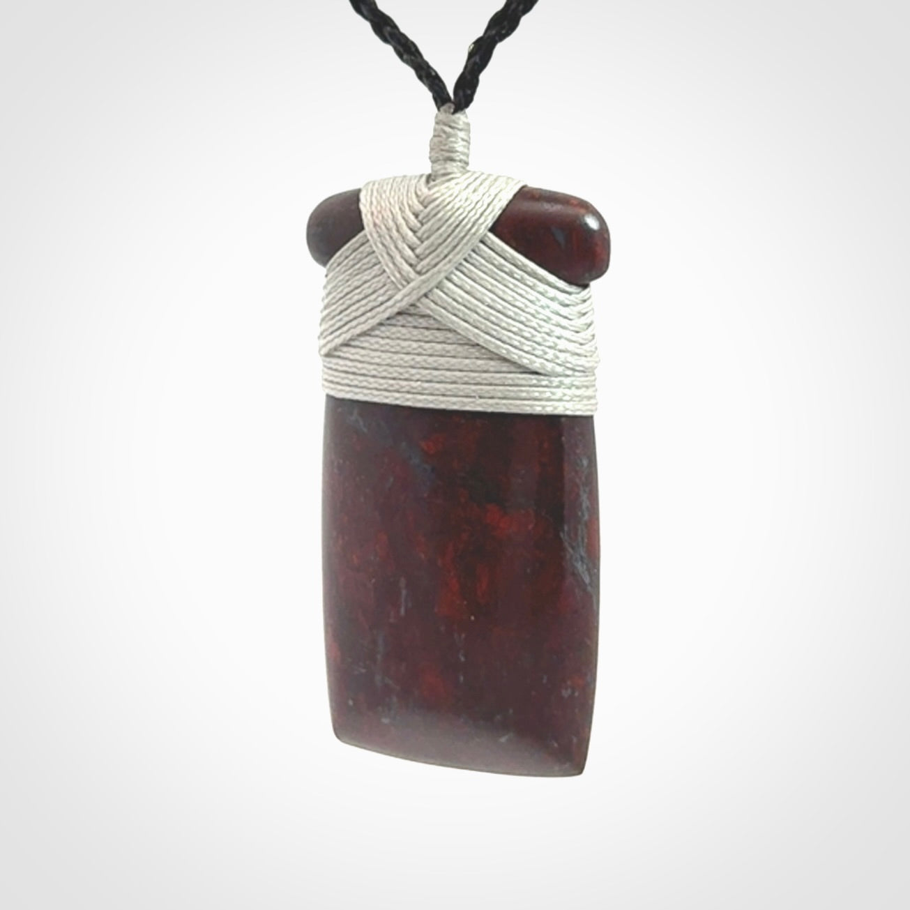 This is a beautiful hand carved Red Jasper Stone toki pendant. A really cool piece that is made from this rare and beautiful material. The red jasper has a very distinctive look and each piece is different. We ship this worldwide and the cost of shipping is included in the price. Provided with adjustable cords and packaged in a woven kete pouch.