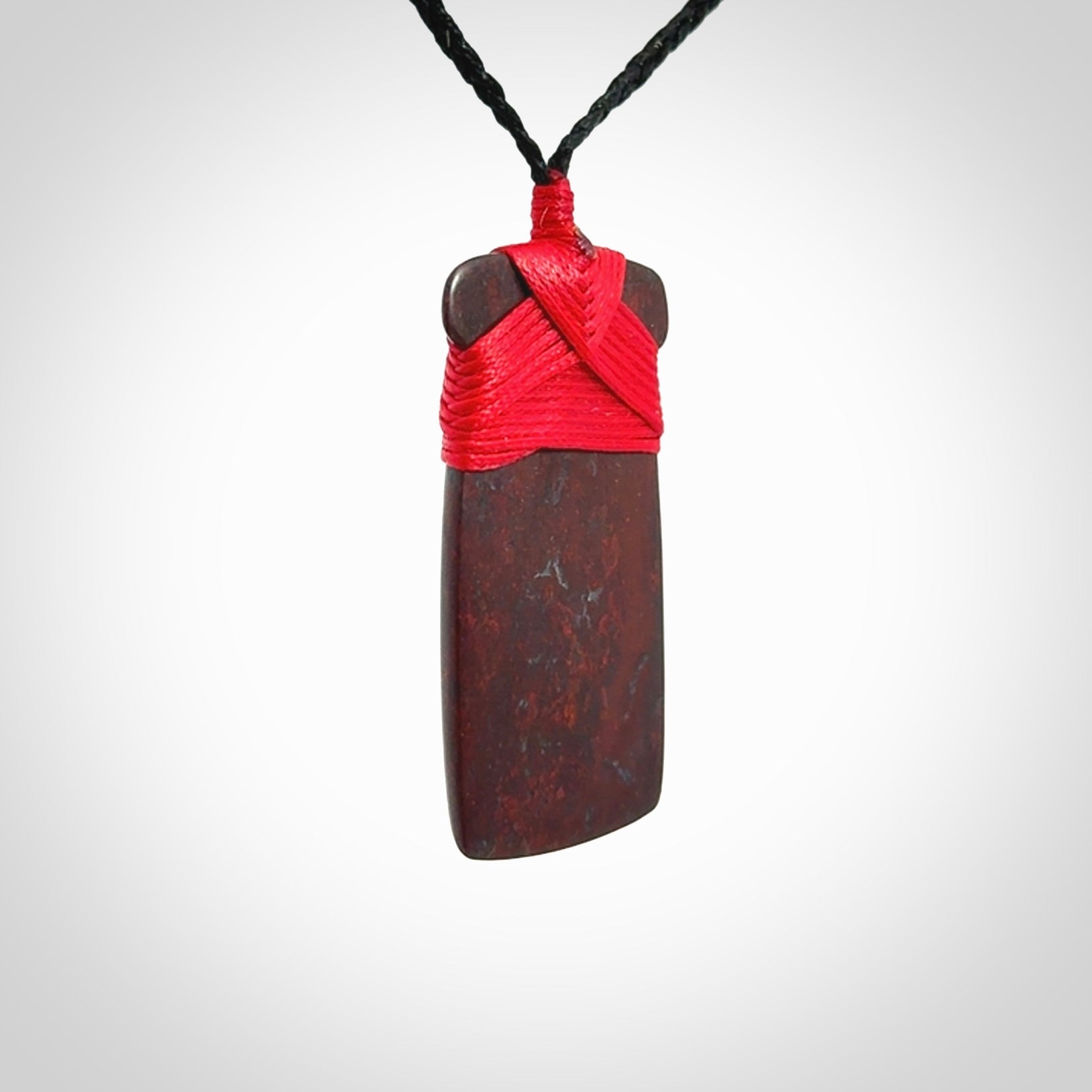 This is a beautiful hand carved Red Jasper Stone toki pendant. A really cool piece that is made from this rare and beautiful material. The red jasper has a very distinctive look and each piece is different. We ship this worldwide and the cost of shipping is included in the price. Provided with adjustable cords and packaged in a woven kete pouch.