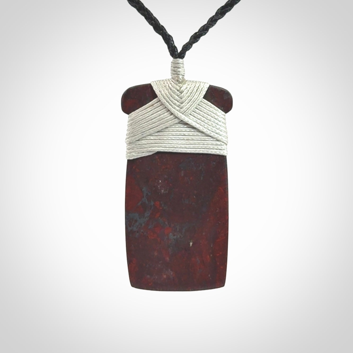 This is a beautiful hand carved Red Jasper Stone toki pendant. A really cool piece that is made from this rare and beautiful material. The red jasper has a very distinctive look and each piece is different. We ship this worldwide and the cost of shipping is included in the price. Provided with adjustable cords and packaged in a woven kete pouch.