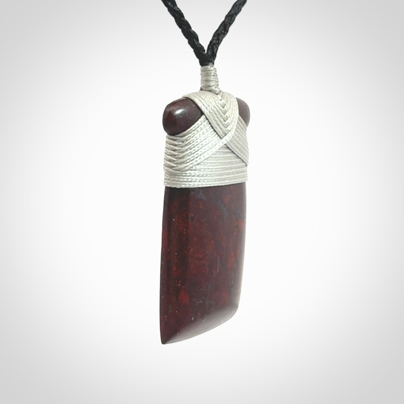 This is a beautiful hand carved Red Jasper Stone toki pendant. A really cool piece that is made from this rare and beautiful material. The red jasper has a very distinctive look and each piece is different. We ship this worldwide and the cost of shipping is included in the price. Provided with adjustable cords and packaged in a woven kete pouch.