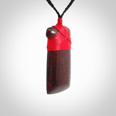 This is a beautiful hand carved Red Jasper Stone toki pendant. A really cool piece that is made from this rare and beautiful material. The red jasper has a very distinctive look and each piece is different. We ship this worldwide and the cost of shipping is included in the price. Provided with adjustable cords and packaged in a woven kete pouch.