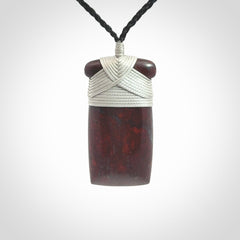 This is a beautiful hand carved Red Jasper Stone toki pendant. A really cool piece that is made from this rare and beautiful material. The red jasper has a very distinctive look and each piece is different. We ship this worldwide and the cost of shipping is included in the price. Provided with adjustable cords and packaged in a woven kete pouch.