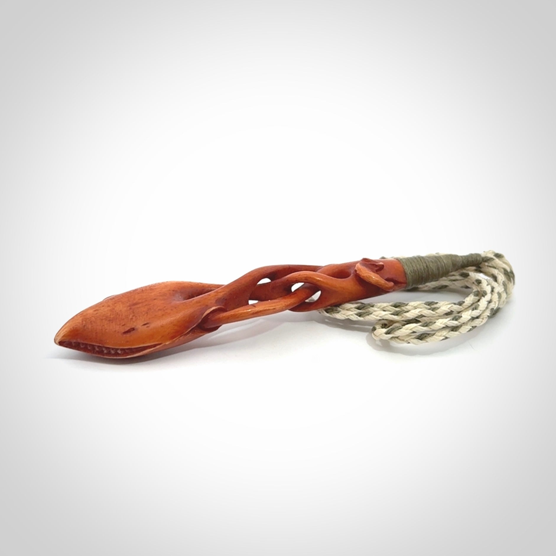 This pendant is carved from cow bone and stained with a homemade tea dye. It is a unique piece of wearable art that is sure to catch the eye. The shape is a complex twist form and has been beautifully hand carved by bone carver Yuri Terenyi.