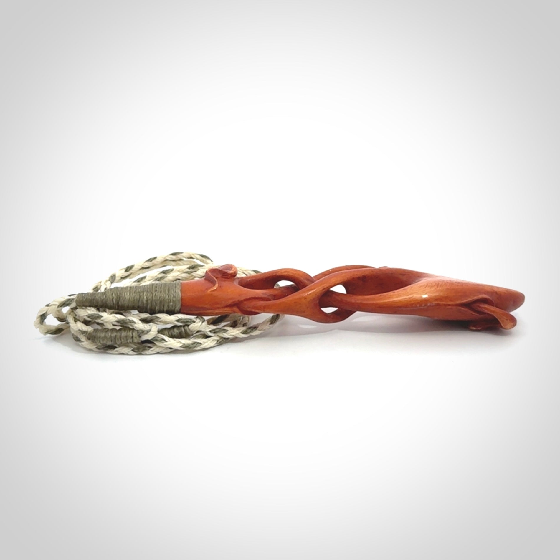 This pendant is carved from cow bone and stained with a homemade tea dye. It is a unique piece of wearable art that is sure to catch the eye. The shape is a complex twist form and has been beautifully hand carved by bone carver Yuri Terenyi.