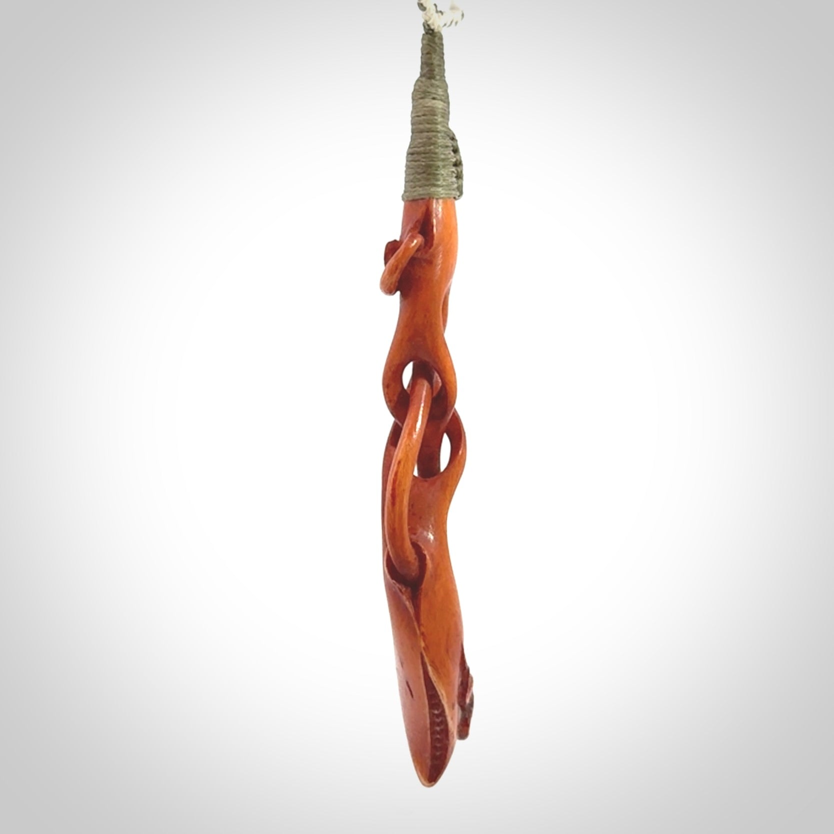 This pendant is carved from cow bone and stained with a homemade tea dye. It is a unique piece of wearable art that is sure to catch the eye. The shape is a complex twist form and has been beautifully hand carved by bone carver Yuri Terenyi.
