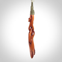 This pendant is carved from cow bone and stained with a homemade tea dye. It is a unique piece of wearable art that is sure to catch the eye. The shape is a complex twist form and has been beautifully hand carved by bone carver Yuri Terenyi.