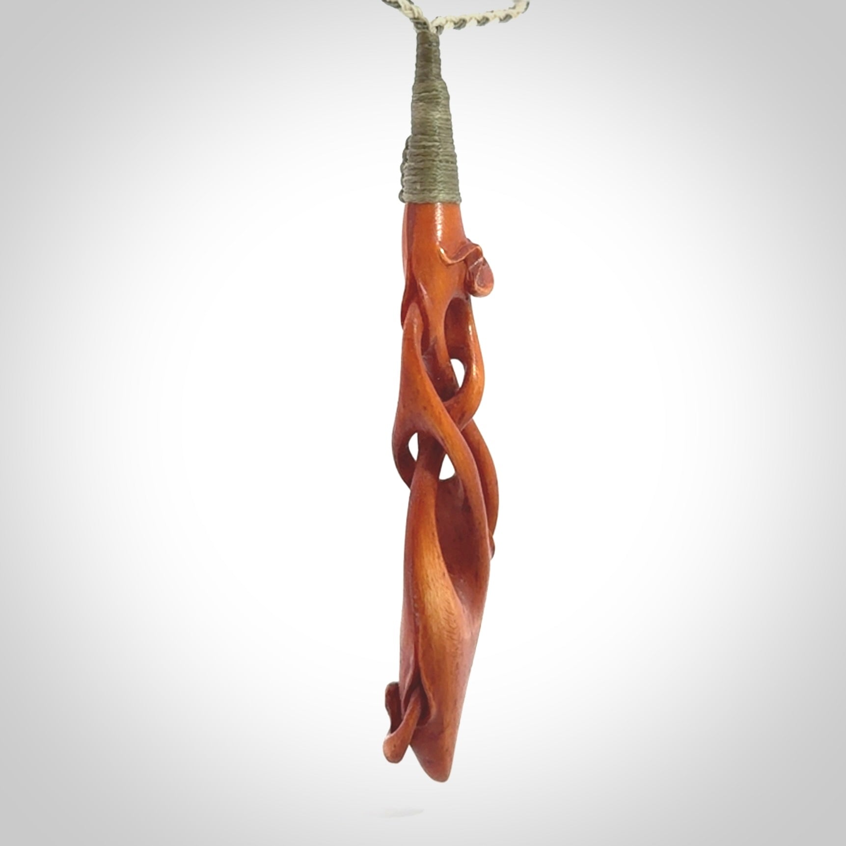 This pendant is carved from cow bone and stained with a homemade tea dye. It is a unique piece of wearable art that is sure to catch the eye. The shape is a complex twist form and has been beautifully hand carved by bone carver Yuri Terenyi.