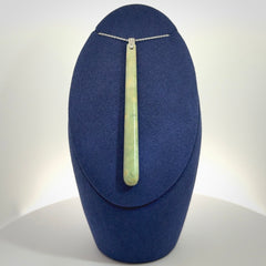 A hand carved New Zealand Jade Drop pendant with sterling silver clasp and chain.