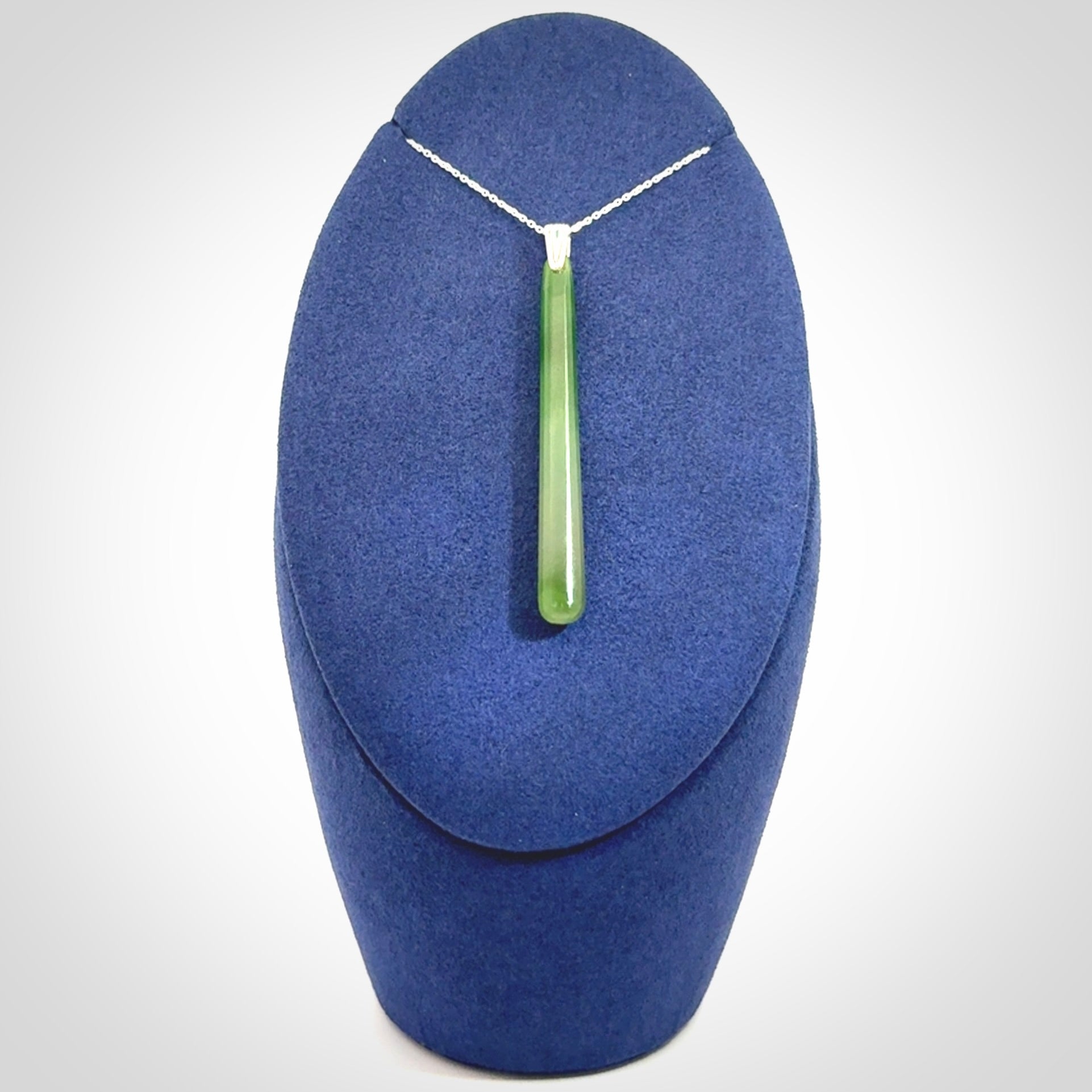 A hand carved New Zealand Jade Drop pendant with sterling silver clasp and chain.
