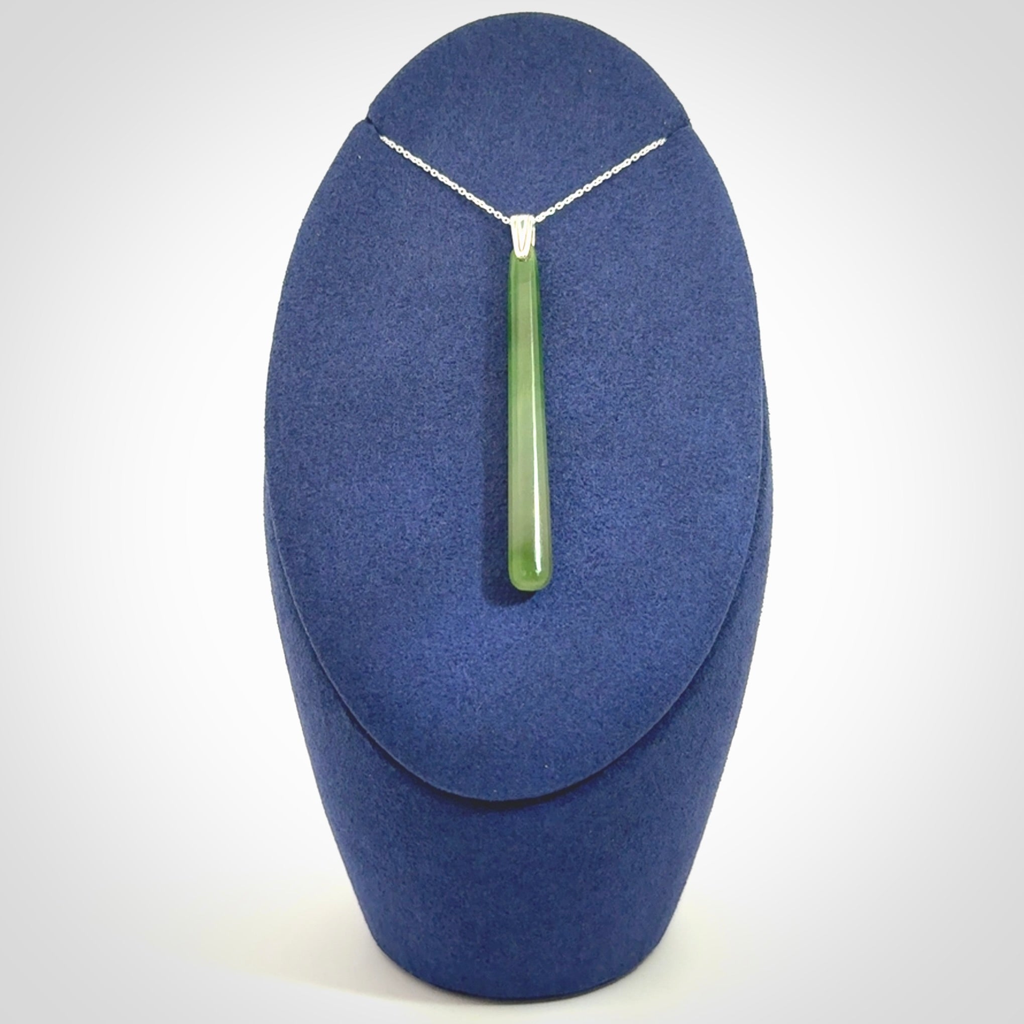 A hand carved New Zealand Jade Drop pendant with sterling silver clasp and chain.