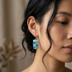 Woman wearing paua earrings