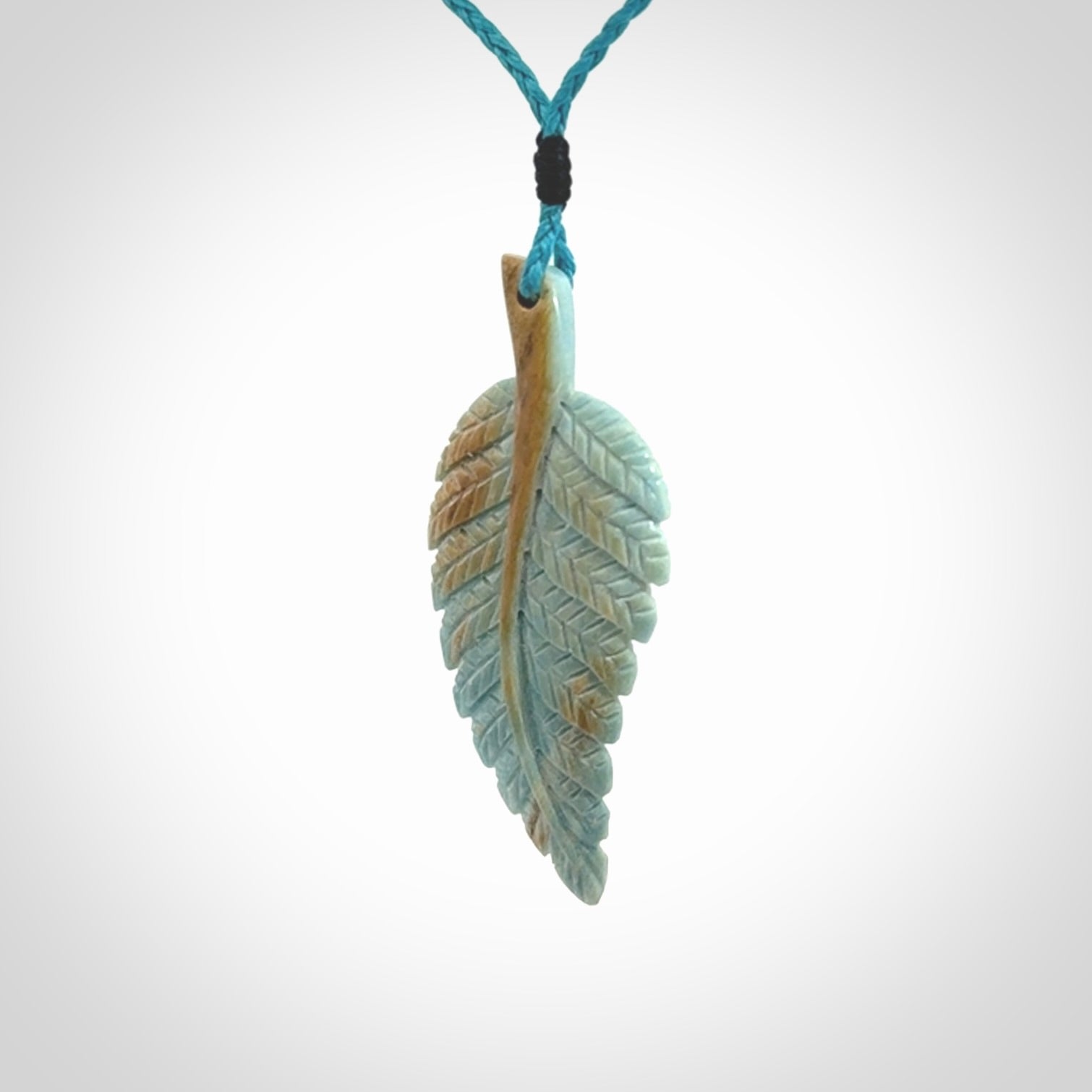 Hand carved blue Mammoth Tusk feather pendant with adjustable cord. Woolly Mammoth tusk feather necklace. Hand carved by NZ Pacific. Art to Wear.