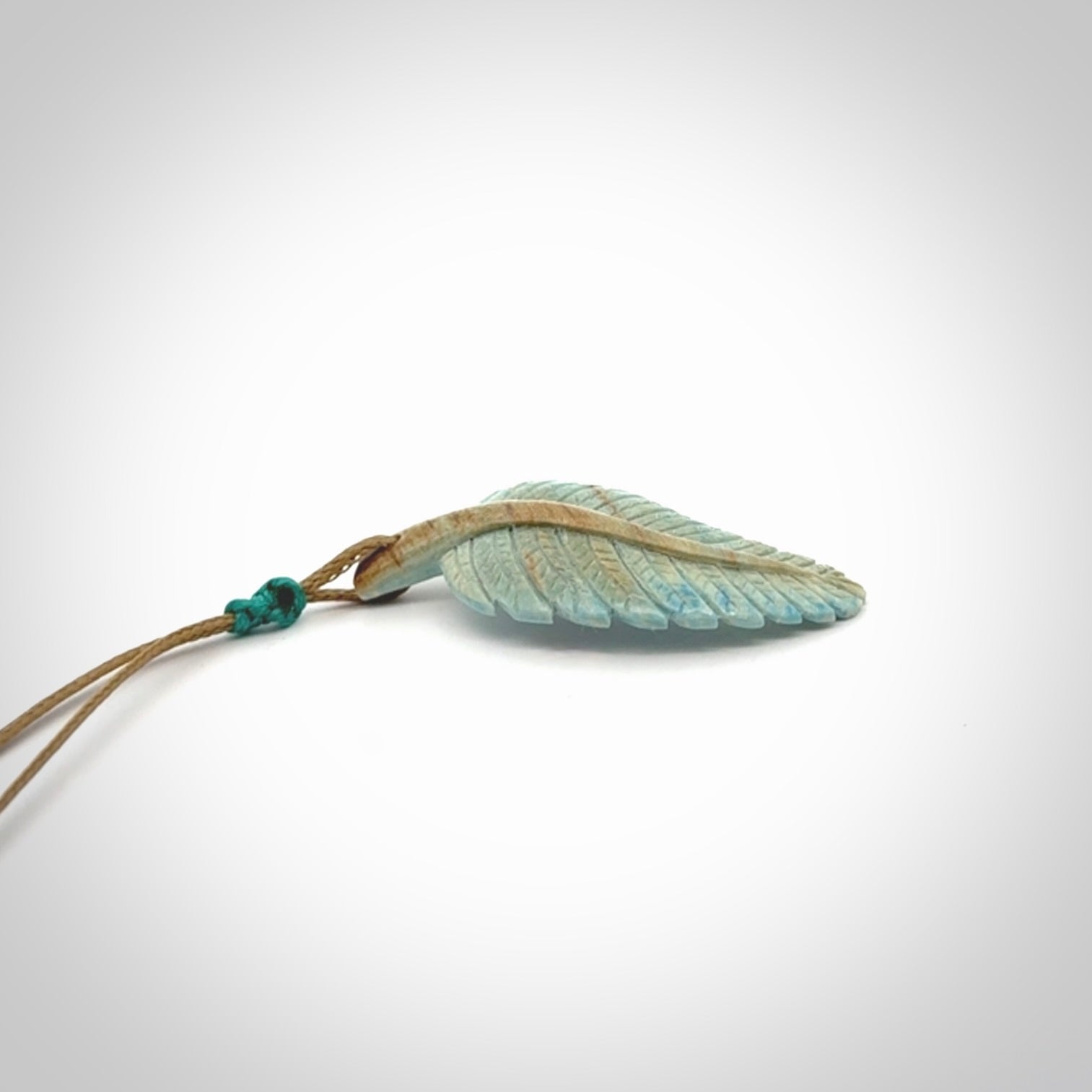 Hand carved blue Mammoth Tusk feather pendant with adjustable cord. Woolly Mammoth tusk feather necklace. Hand carved by NZ Pacific. Art to Wear.