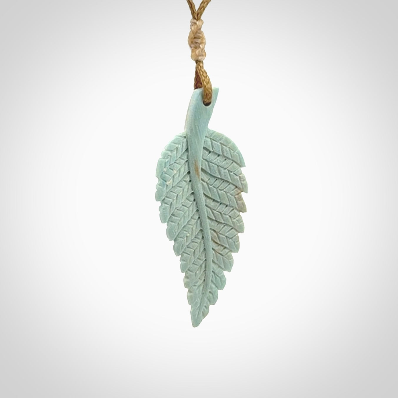 Hand carved blue Mammoth Tusk feather pendant with adjustable cord. Woolly Mammoth tusk feather necklace. Hand carved by NZ Pacific. Art to Wear.