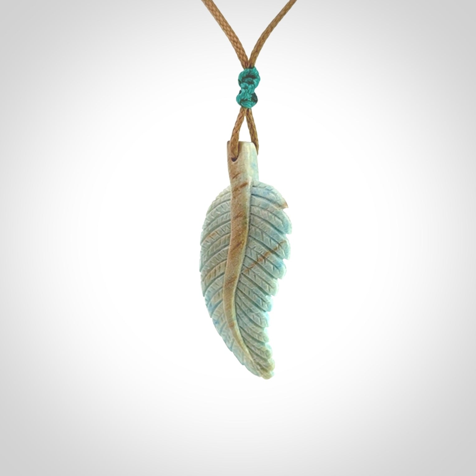 Hand carved blue Mammoth Tusk feather pendant with adjustable cord. Woolly Mammoth tusk feather necklace. Hand carved by NZ Pacific. Art to Wear.