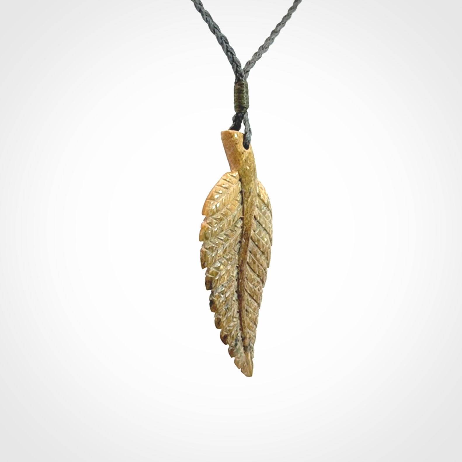 Hand carved blue Mammoth Tusk feather pendant with hand plaited adjustable cord. Woolly Mammoth tusk feather necklace. Hand carved by NZ Pacific. Art to Wear.