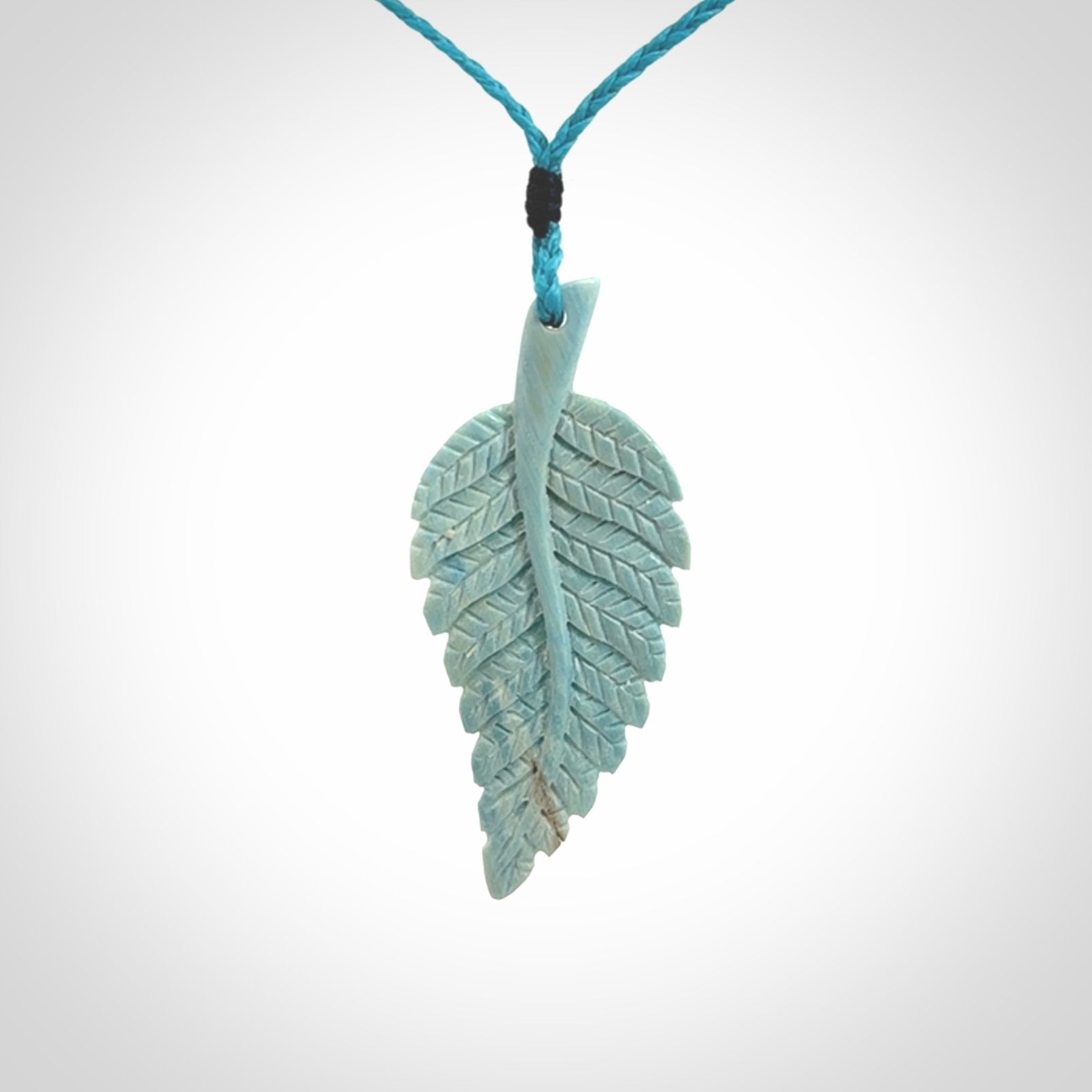 Hand carved blue Mammoth Tusk feather pendant with adjustable cord. Woolly Mammoth tusk feather necklace. Hand carved by NZ Pacific. Art to Wear.