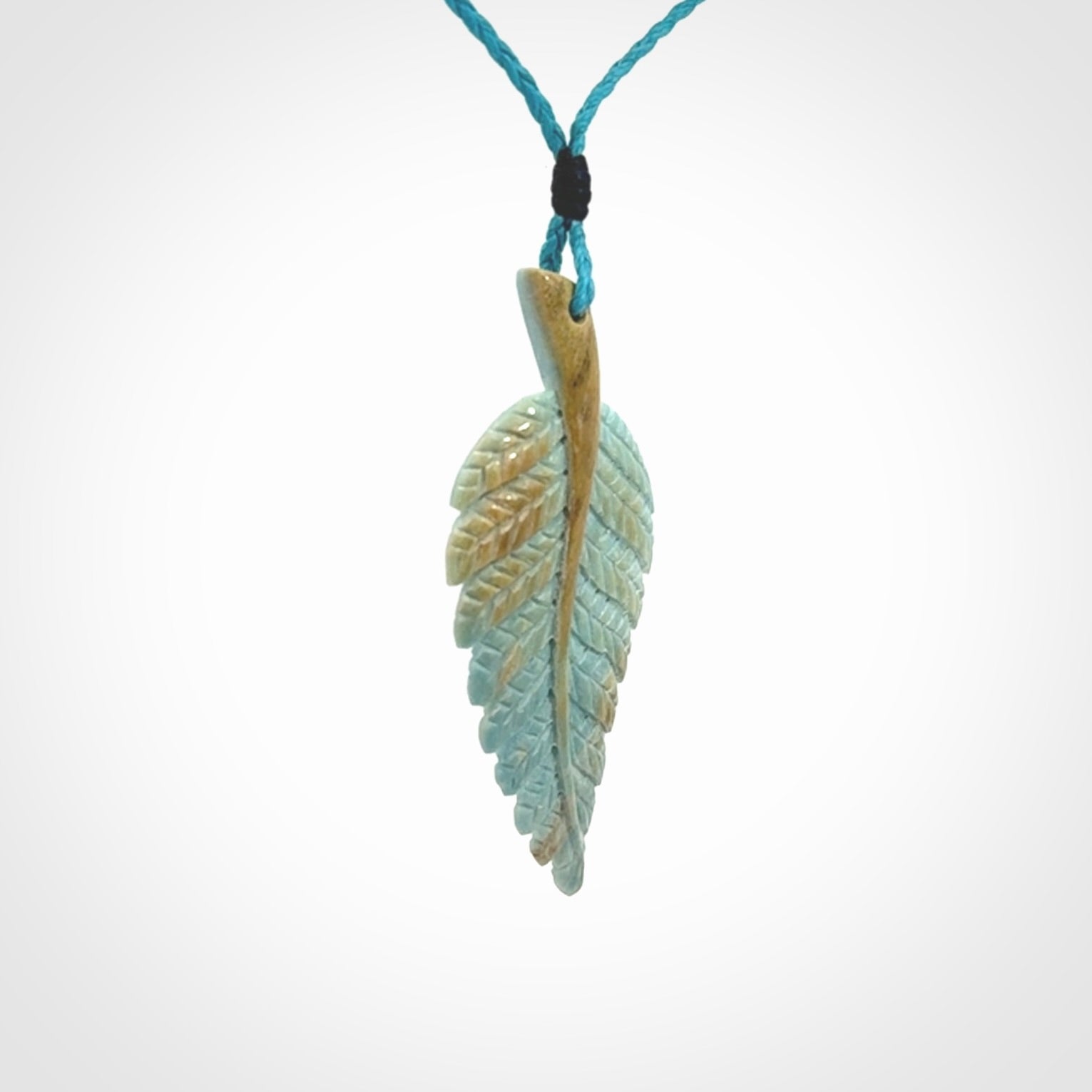 Hand carved blue Mammoth Tusk feather pendant with adjustable cord. Woolly Mammoth tusk feather necklace. Hand carved by NZ Pacific. Art to Wear.