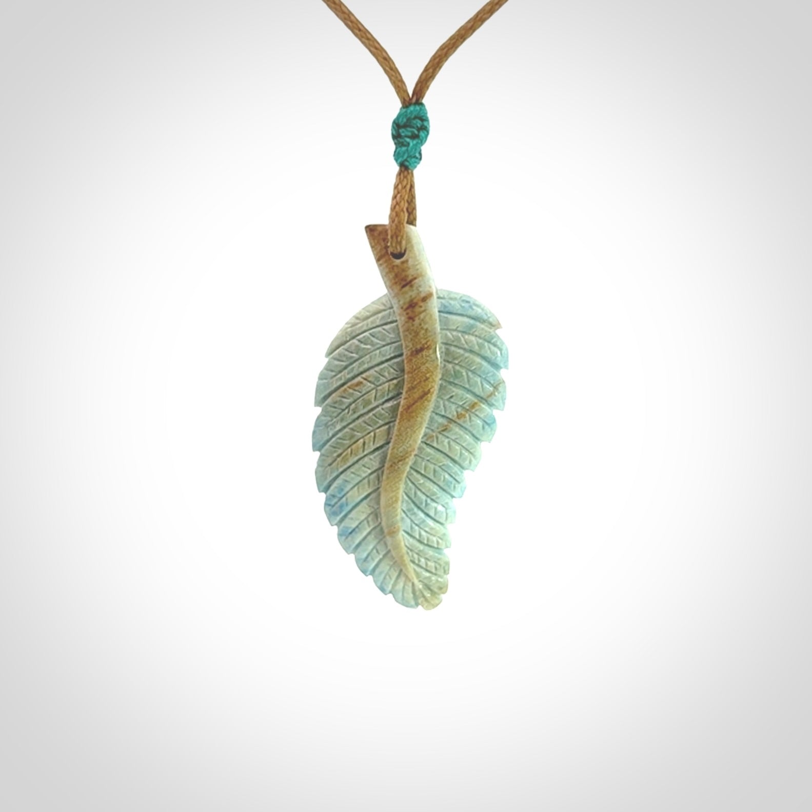 Hand carved blue Mammoth Tusk feather pendant with adjustable cord. Woolly Mammoth tusk feather necklace. Hand carved by NZ Pacific. Art to Wear.