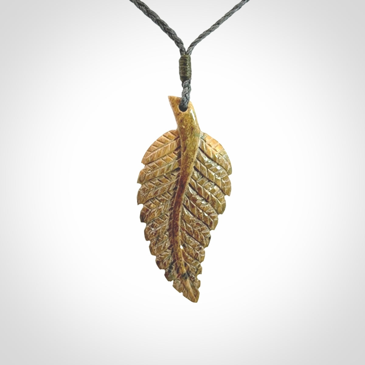 Hand carved blue Mammoth Tusk feather pendant with hand plaited adjustable cord. Woolly Mammoth tusk feather necklace. Hand carved by NZ Pacific. Art to Wear.