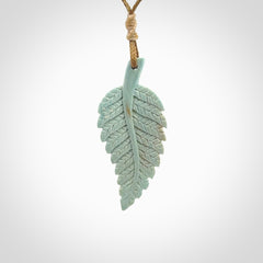 Hand carved blue Mammoth Tusk feather pendant with adjustable cord. Woolly Mammoth tusk feather necklace. Hand carved by NZ Pacific. Art to Wear.