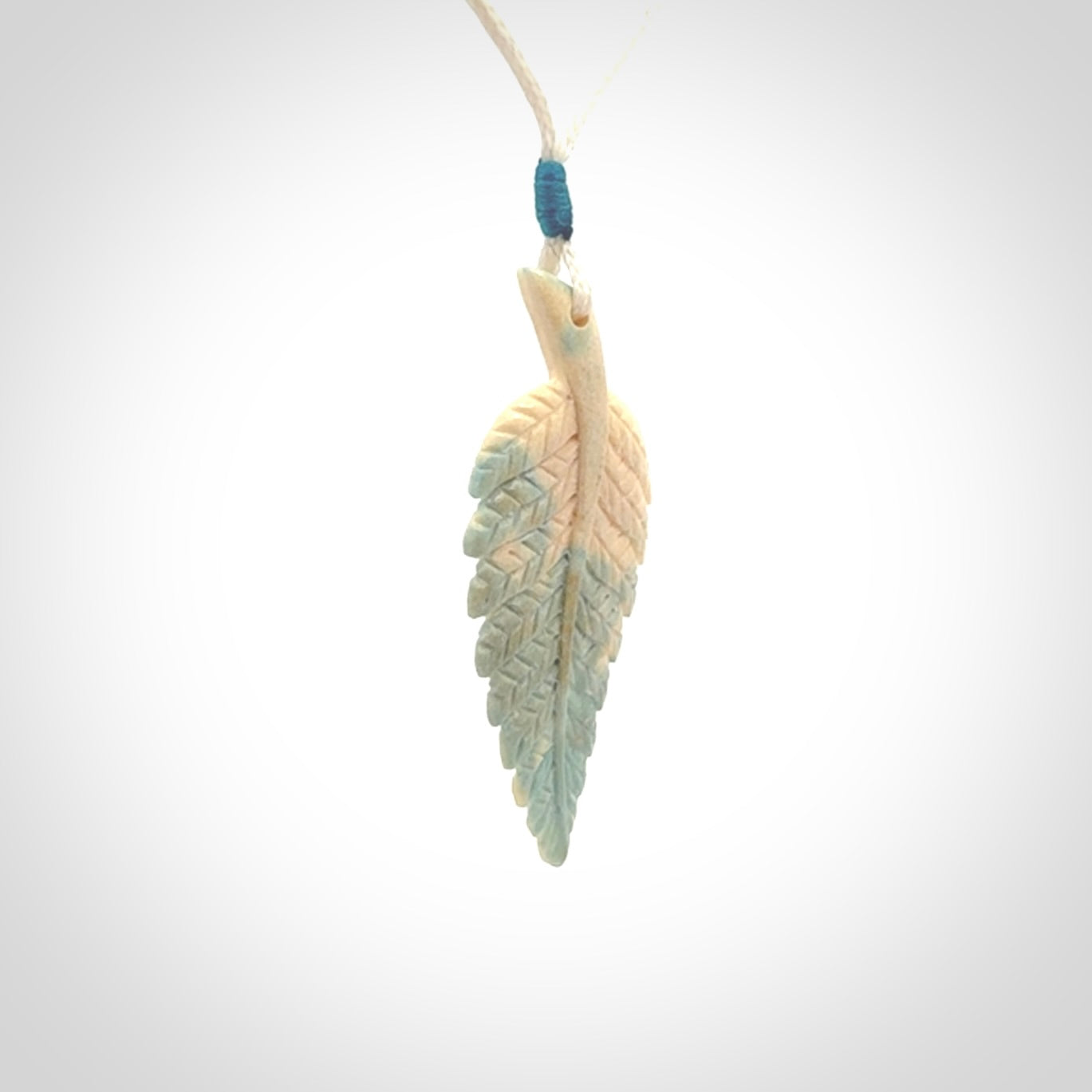 Hand carved blue Mammoth Tusk feather pendant with adjustable cord. Woolly Mammoth tusk feather necklace. Hand carved by NZ Pacific. Art to Wear.