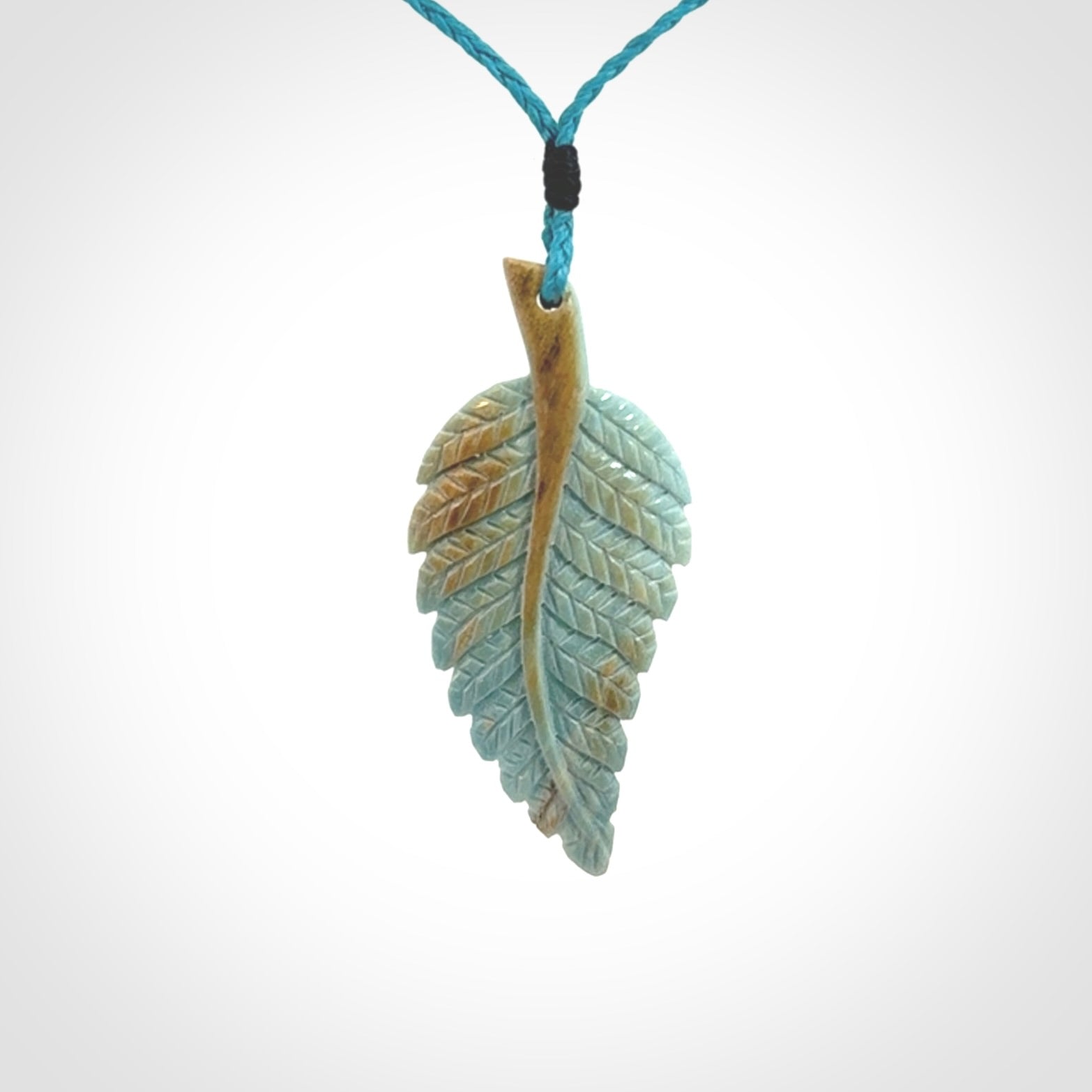 Hand carved blue Mammoth Tusk feather pendant with adjustable cord. Woolly Mammoth tusk feather necklace. Hand carved by NZ Pacific. Art to Wear.