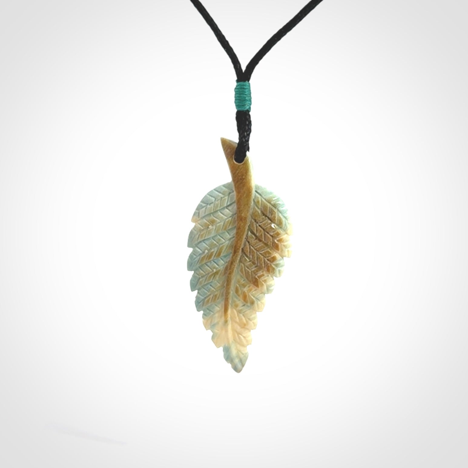 Hand carved blue Mammoth Tusk feather pendant with adjustable cord. Woolly Mammoth tusk feather necklace. Hand carved by NZ Pacific. Art to Wear.