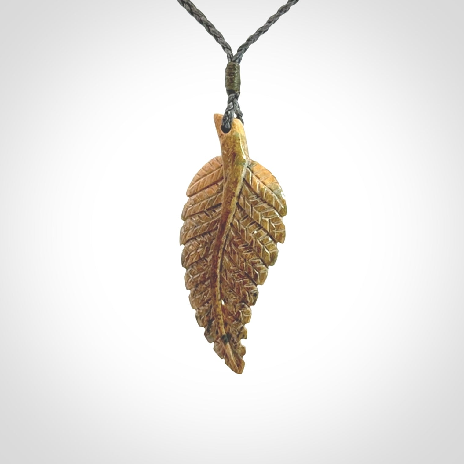 Hand carved blue Mammoth Tusk feather pendant with hand plaited adjustable cord. Woolly Mammoth tusk feather necklace. Hand carved by NZ Pacific. Art to Wear.