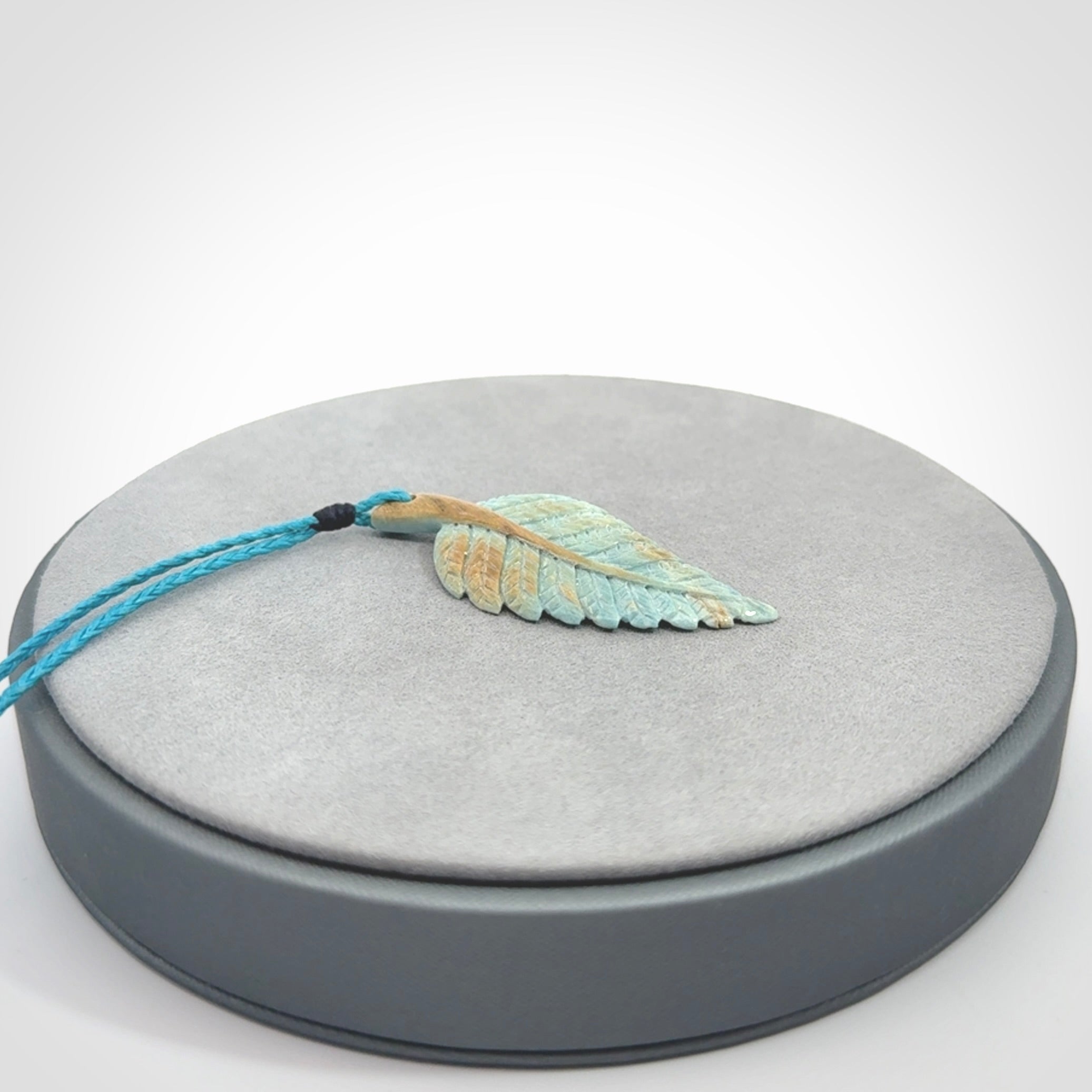 Hand carved blue Mammoth Tusk feather pendant with adjustable cord. Woolly Mammoth tusk feather necklace. Hand carved by NZ Pacific. Art to Wear.