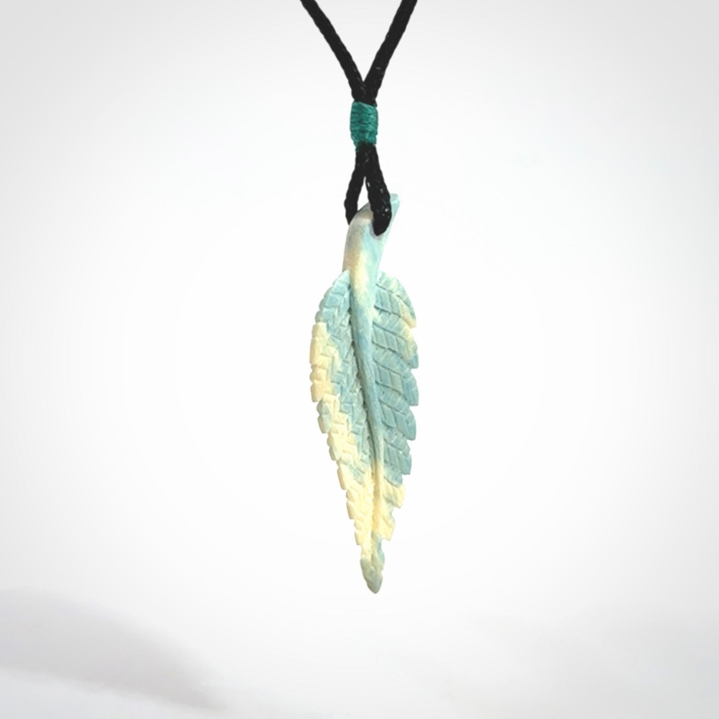 Hand carved blue Mammoth Tusk feather pendant with adjustable cord. Woolly Mammoth tusk feather necklace. Hand carved by NZ Pacific. Art to Wear.