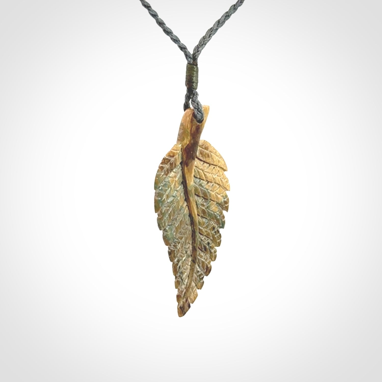 Hand carved blue Mammoth Tusk feather pendant with hand plaited adjustable cord. Woolly Mammoth tusk feather necklace. Hand carved by NZ Pacific. Art to Wear.