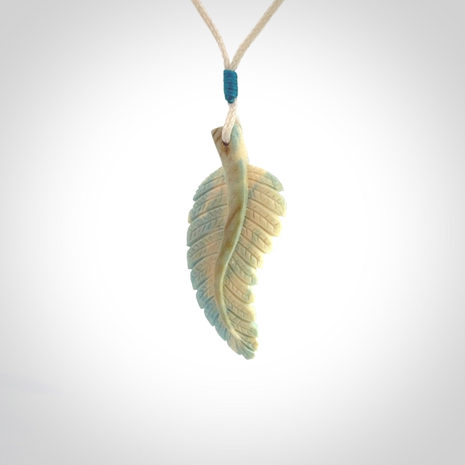 Hand carved blue Mammoth Tusk feather pendant with adjustable cord. Woolly Mammoth tusk feather necklace. Hand carved by NZ Pacific. Art to Wear.