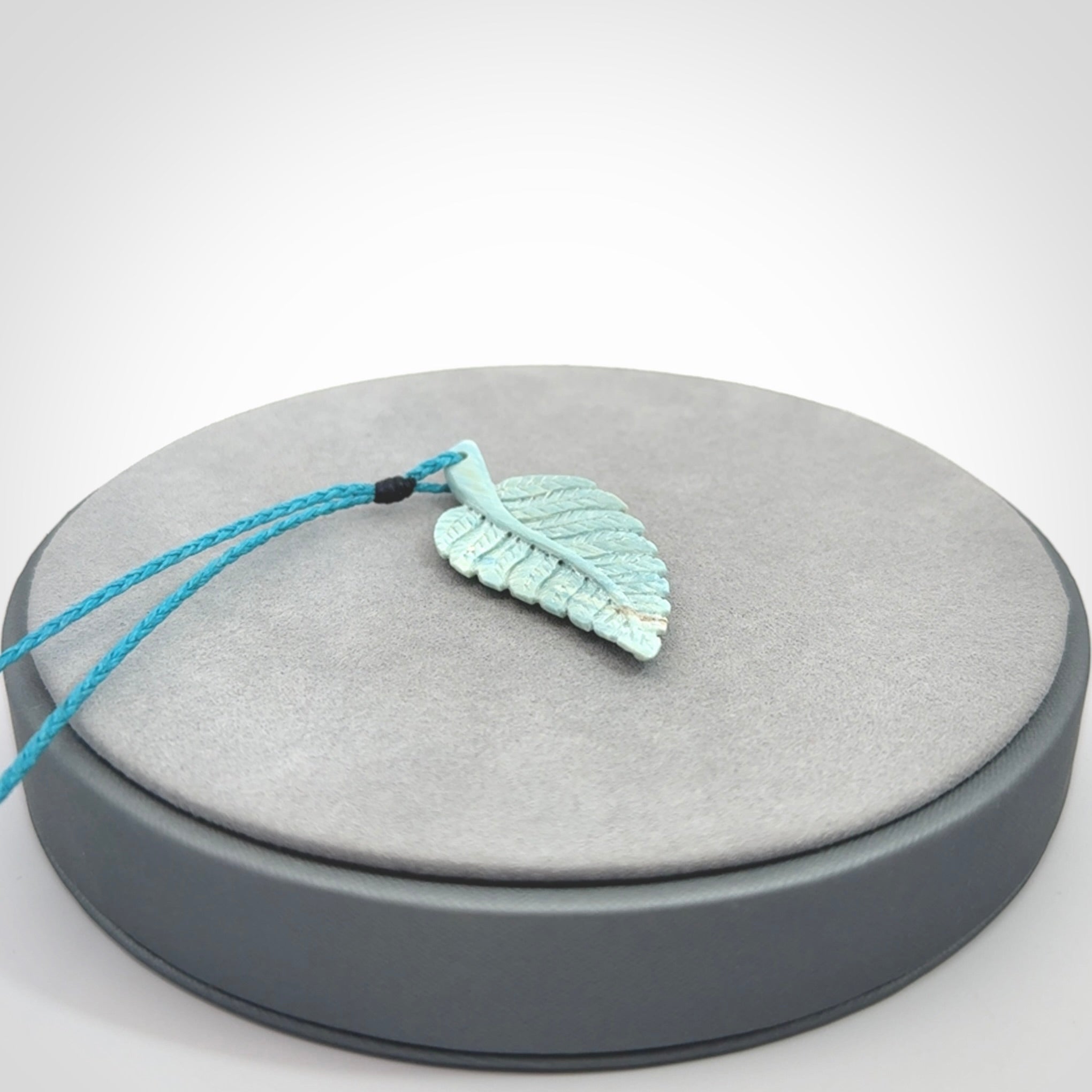 Hand carved blue Mammoth Tusk feather pendant with adjustable cord. Woolly Mammoth tusk feather necklace. Hand carved by NZ Pacific. Art to Wear.