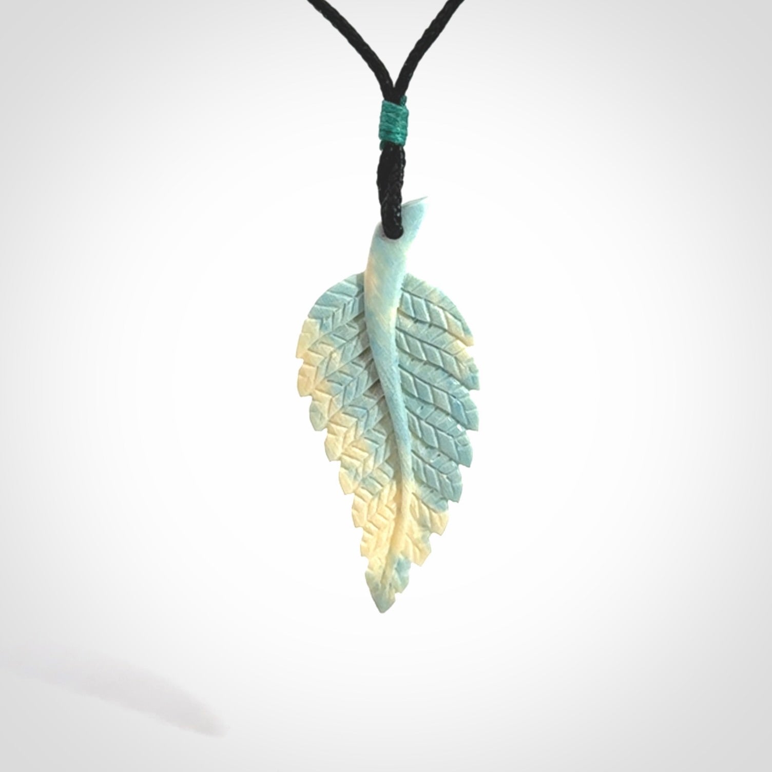 Hand carved blue Mammoth Tusk feather pendant with adjustable cord. Woolly Mammoth tusk feather necklace. Hand carved by NZ Pacific. Art to Wear.