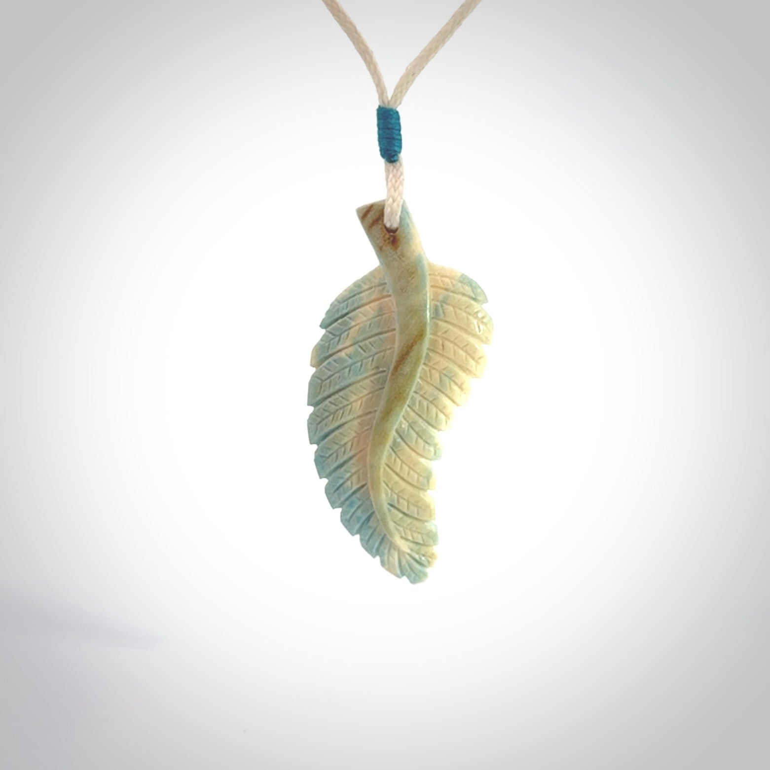 Hand carved blue Mammoth Tusk feather pendant with adjustable cord. Woolly Mammoth tusk feather necklace. Hand carved by NZ Pacific. Art to Wear.