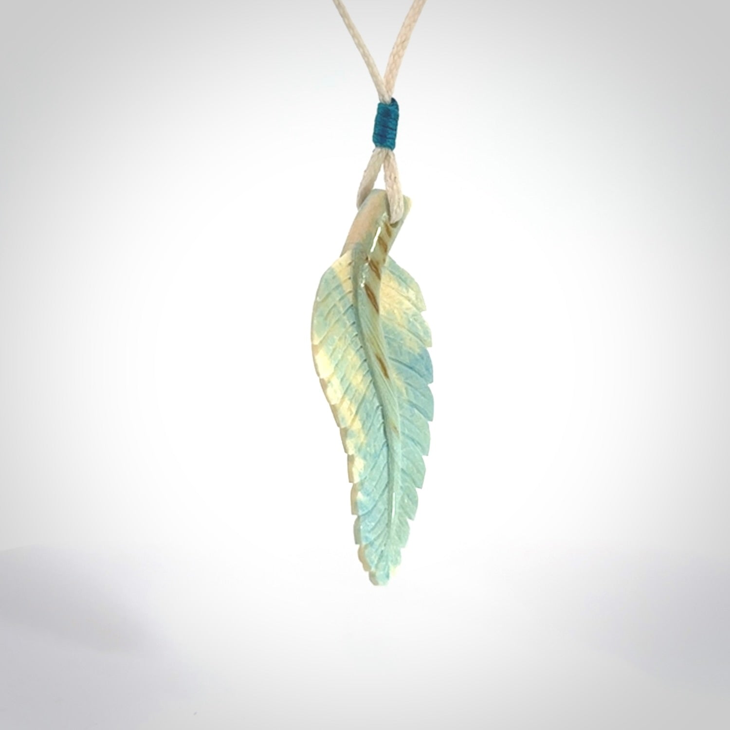 Hand carved blue Mammoth Tusk feather pendant with adjustable cord. Woolly Mammoth tusk feather necklace. Hand carved by NZ Pacific. Art to Wear.