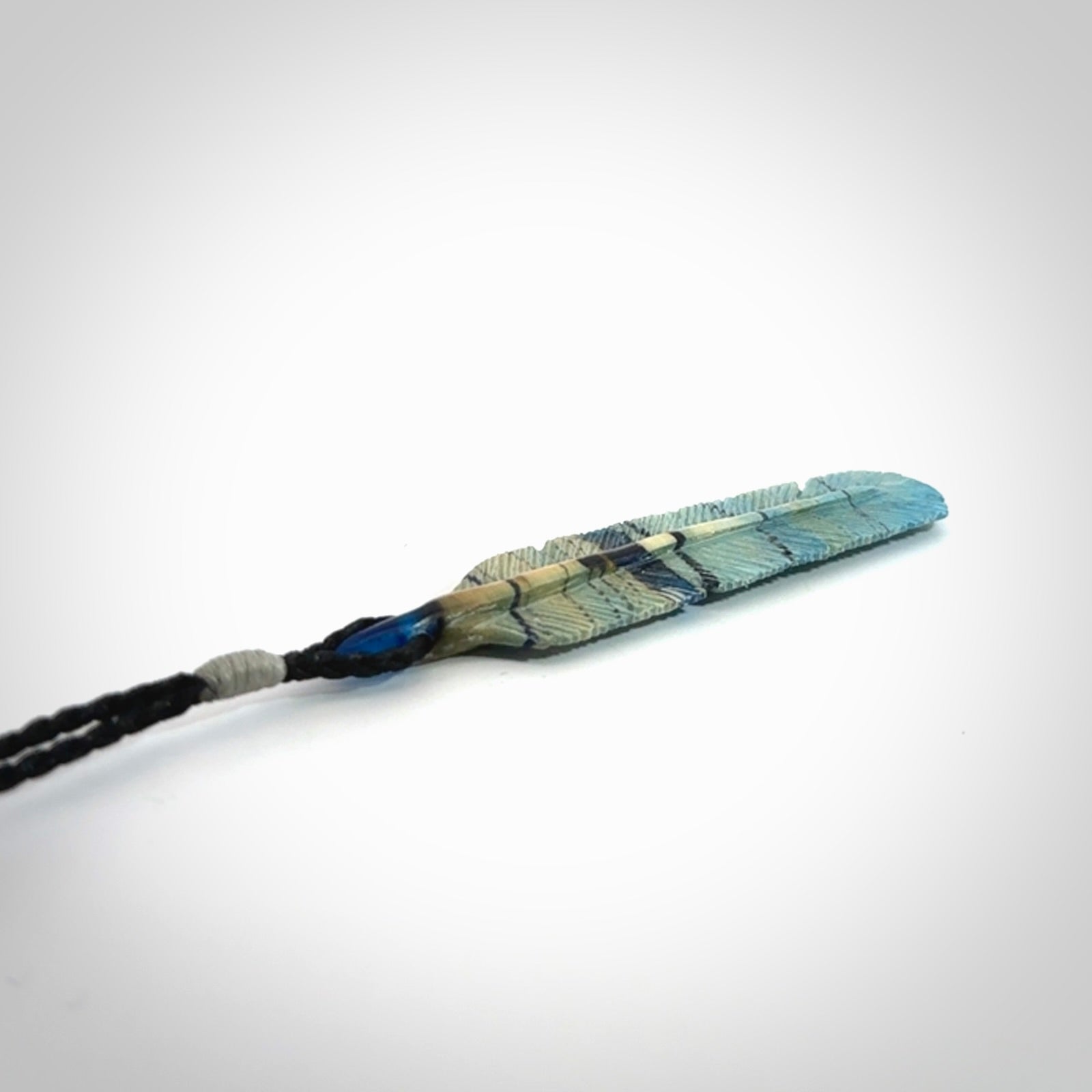Hand carved Woolly Mammoth Tusk Blue Jay feather pendant. Hand made from Mammoth Tusk stabilised with resin. Art to Wear, one only. Provided with adjustable cord.